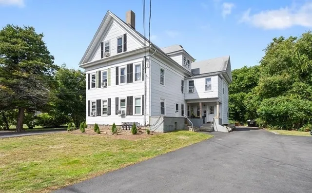 a front view of a house with a yard table and chairs