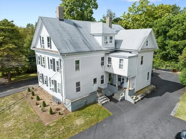 an aerial view of a house with yard