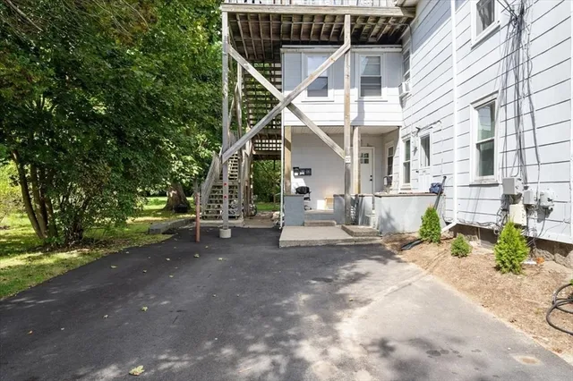 a view of a house with backyard and sitting area