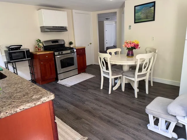 a dining room with furniture and wooden floor