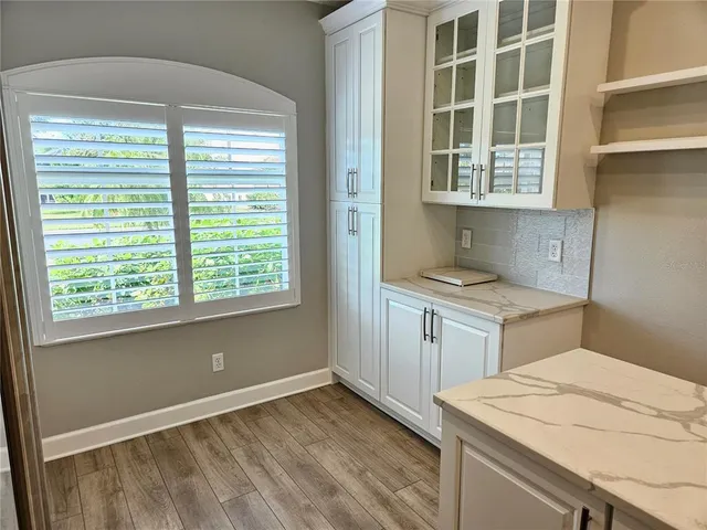 a room with a bed and a refrigerator