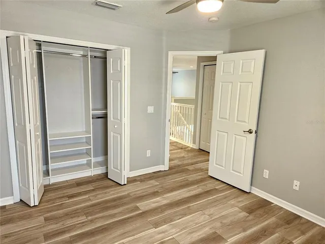 a view of a patio with dining table and chairs with wooden floor and fence