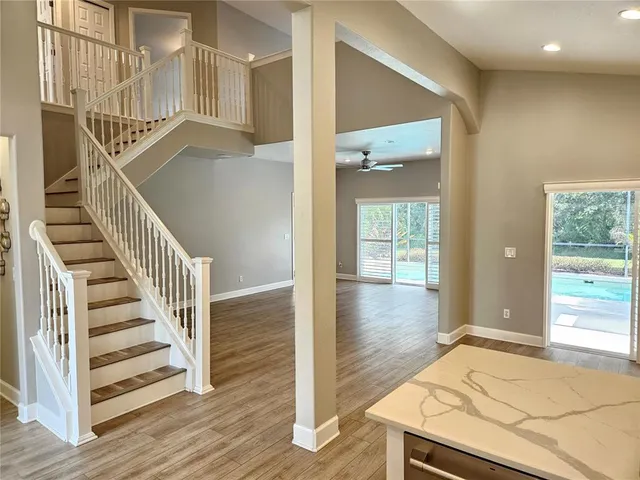 a view of a hallway with wooden floor and entryway
