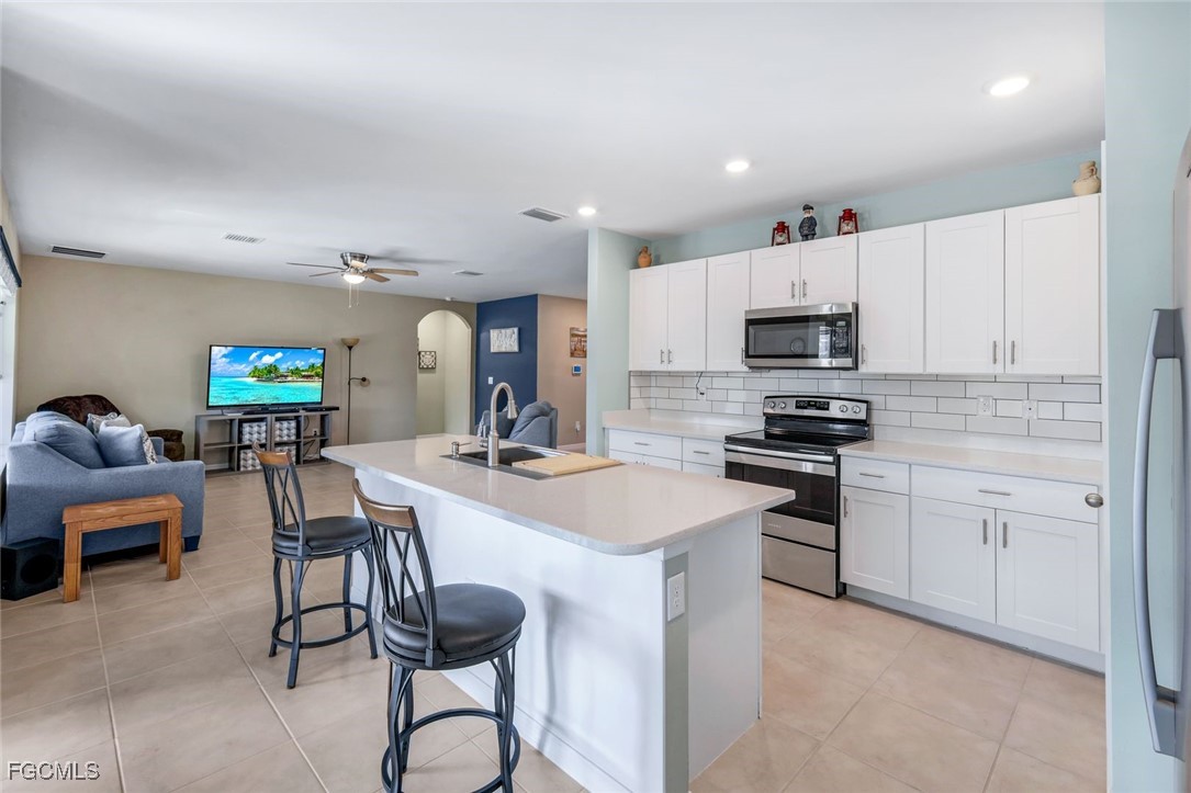 566 Corrientes Circle Punta Gorda, FL 33983 - Photo 15 of 36 a kitchen with cabinets a sink and appliances