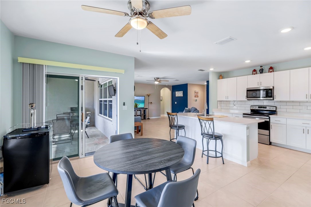 566 Corrientes Circle Punta Gorda, FL 33983 - Photo 18 of 36 a view of kitchen with refrigerator a dining table and chairs