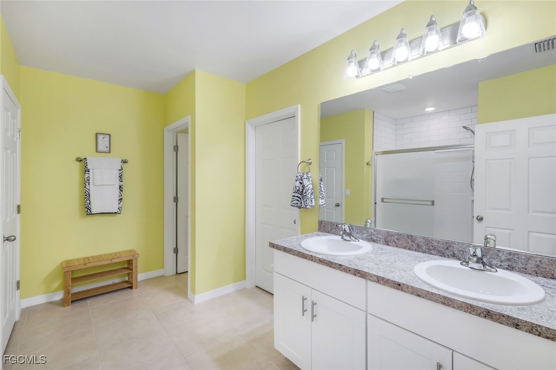 566 Corrientes Circle Punta Gorda, FL 33983 - Photo 20 of 36 a bathroom with a granite countertop sink and a mirror