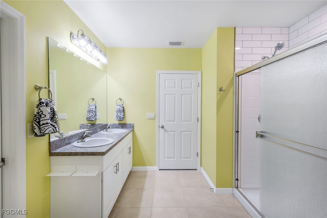 566 Corrientes Circle Punta Gorda, FL 33983 - Photo 21 of 36 a bathroom with a tub sink and mirror