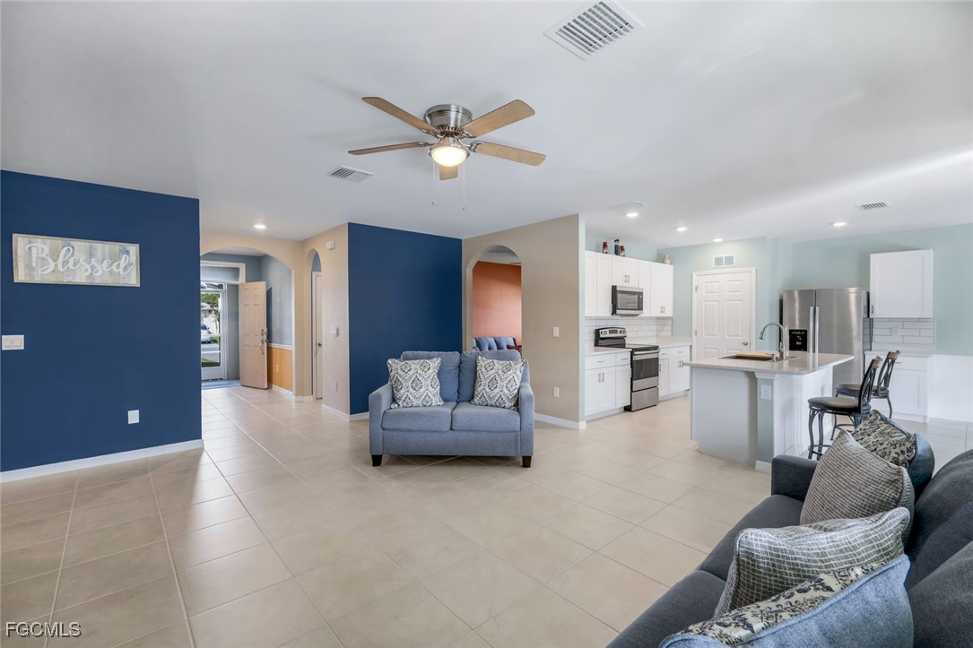 566 Corrientes Circle Punta Gorda, FL 33983 - Photo 9 of 36 a living room with furniture and a view of kitchen