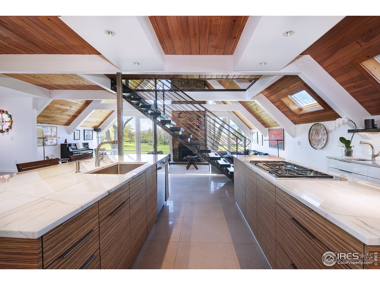 7006 Roaring Fork Trail Boulder, CO 80301 - Photo 16 of 40 a kitchen with stainless steel appliances granite countertop a sink a stove and a wooden floors