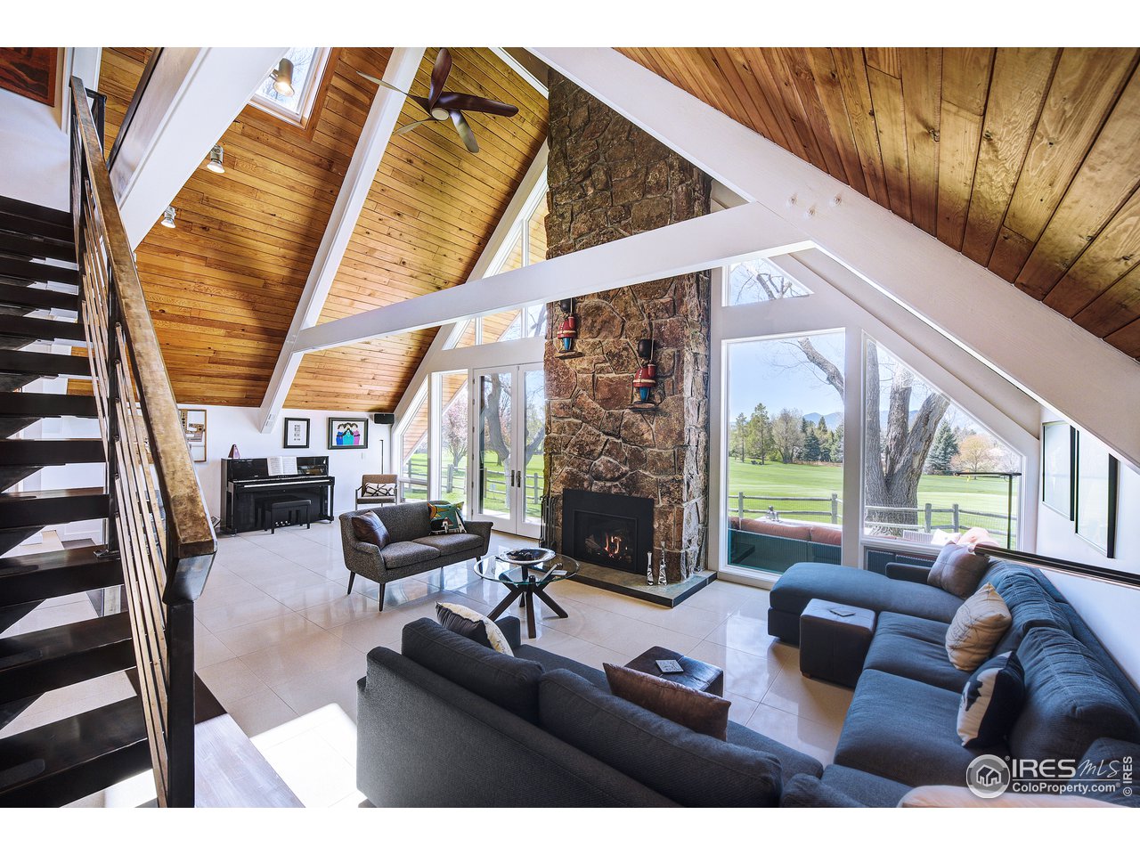 7006 Roaring Fork Trail Boulder, CO 80301 - Photo 21 of 40 a living room with furniture a couch and a large window