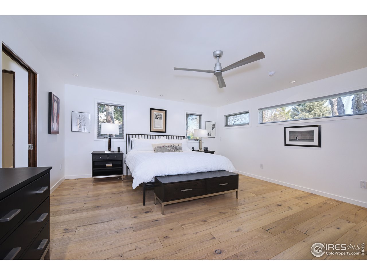 7006 Roaring Fork Trail Boulder, CO 80301 - Photo 23 of 40 a spacious bedroom with a bed and a dresser