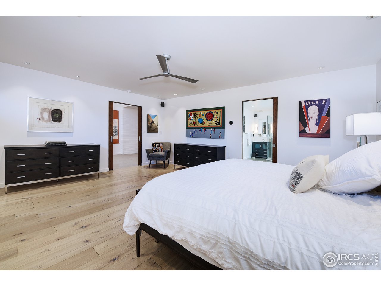 7006 Roaring Fork Trail Boulder, CO 80301 - Photo 24 of 40 a bedroom with a bed and a flat screen tv
