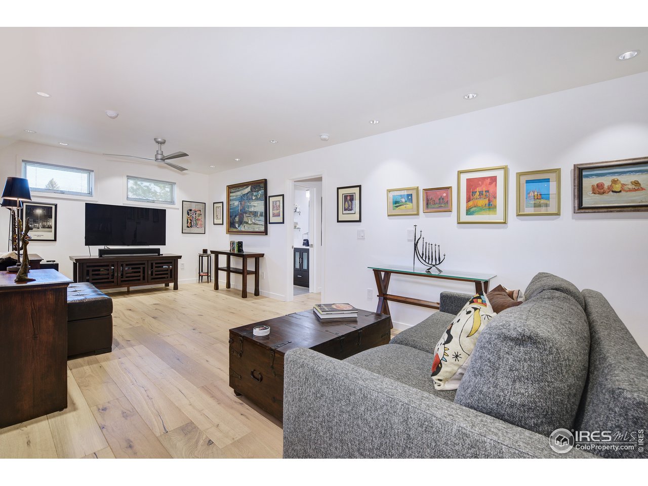 7006 Roaring Fork Trail Boulder, CO 80301 - Photo 28 of 40 a living room with furniture and a flat screen tv