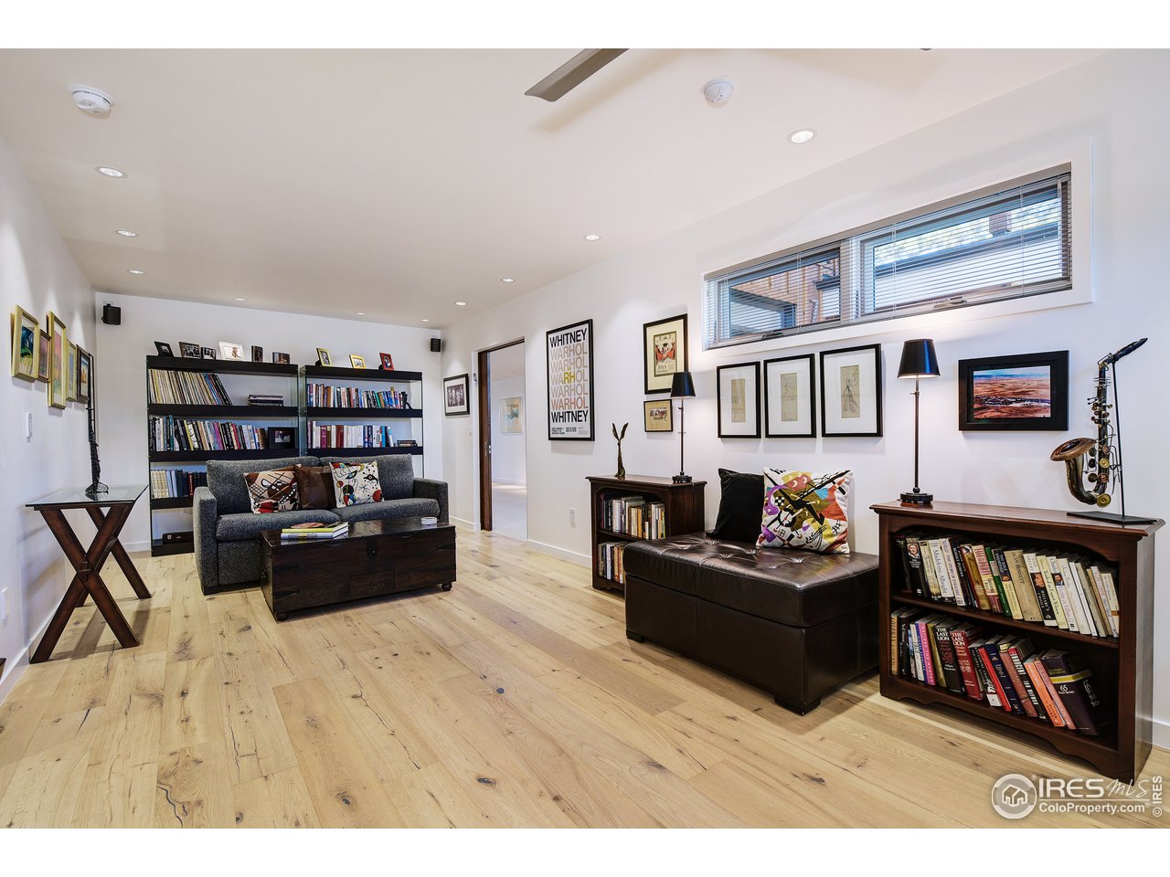 7006 Roaring Fork Trail Boulder, CO 80301 - Photo 29 of 40 a living room with furniture and a book shelf