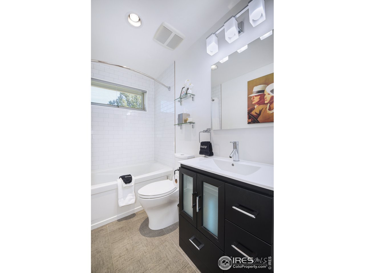 7006 Roaring Fork Trail Boulder, CO 80301 - Photo 30 of 40 a spacious bathroom with a sink toilet a mirror and vanity