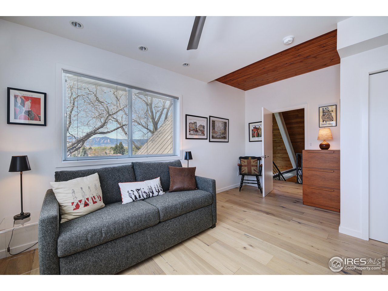 7006 Roaring Fork Trail Boulder, CO 80301 - Photo 36 of 40 a living room with furniture and a wooden floor