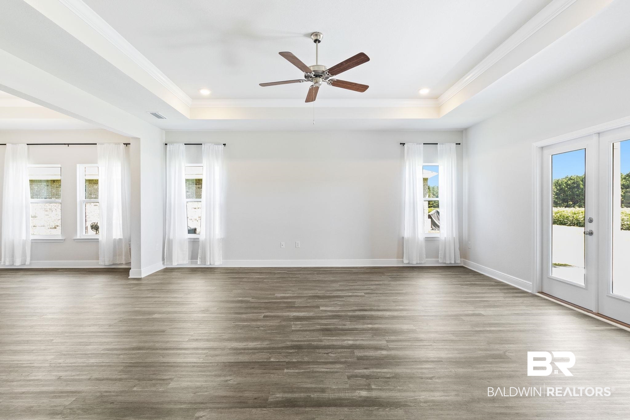 11303 Genuine Risk Circle Daphne, AL 36526 - Photo 13 of 100 Great room has a trey ceiling, crown molding and lots of natural light
