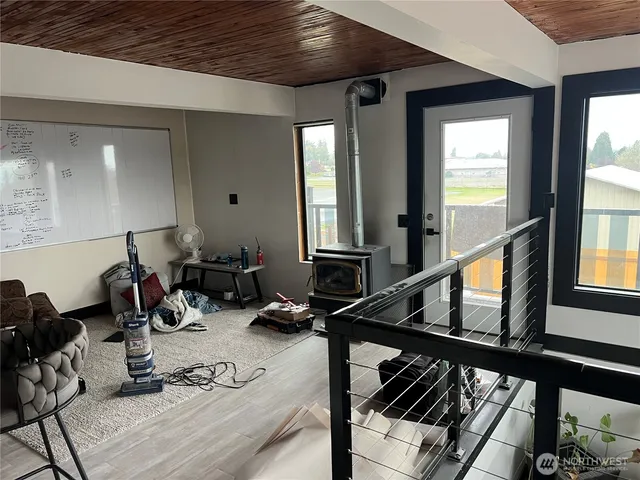 a room with gym equipment and view of living room view