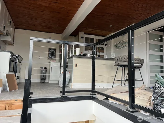 a view of a room with wooden floor and windows