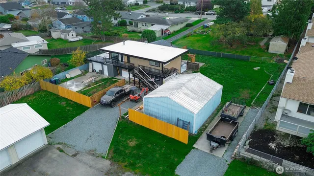 an aerial view of a house with swimming pool garden and patio