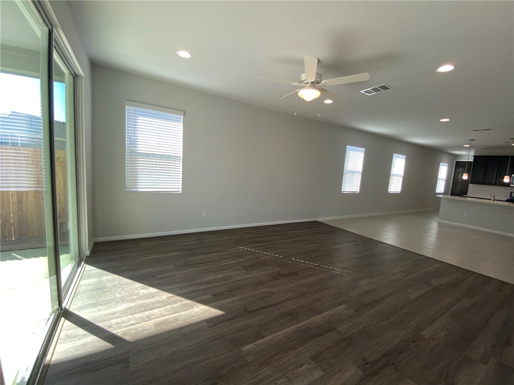 384 Gaida Loop Georgetown, TX 78628 - Photo 8 of 20 Very open and bright living space with extra large sliding doors leading to a generous covered patio great for entertaining.