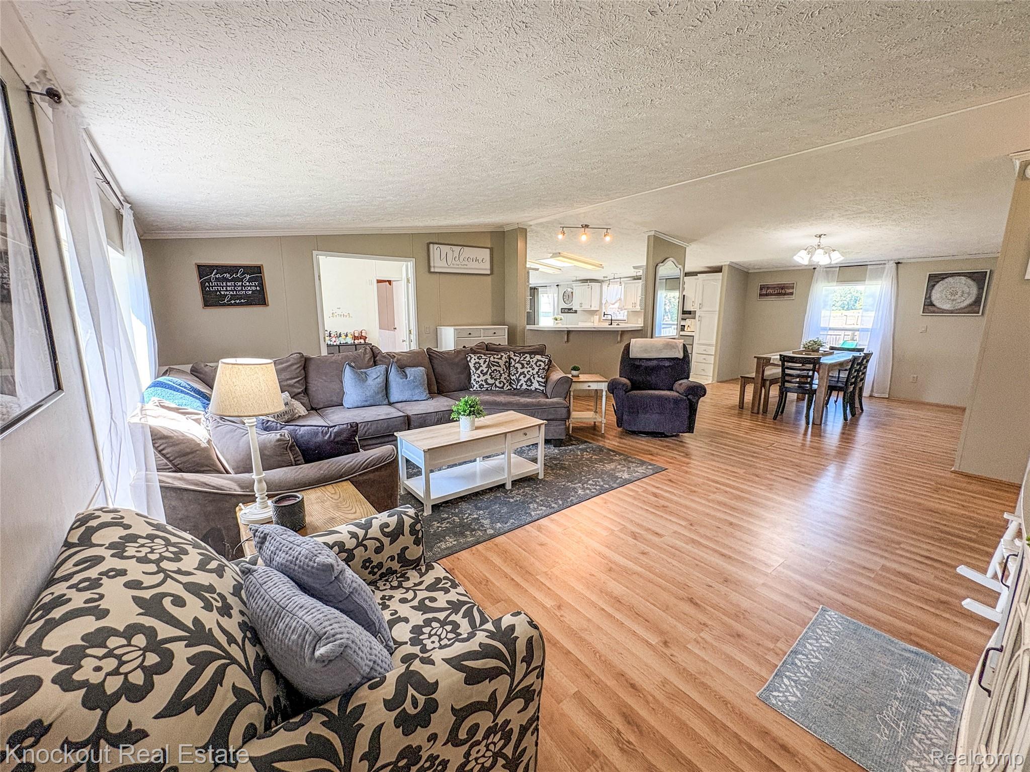 7760 Bell Road Birch Run, MI 48415 - Photo 3 of 68 Open-concept living area featuring wood-finish flooring, recessed lighting, and a neutral wall palette