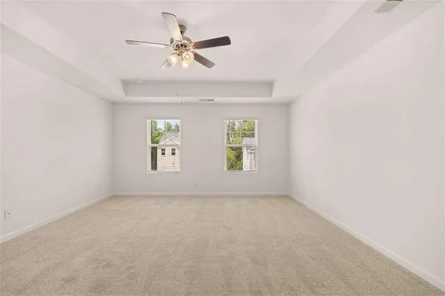 a view of a livingroom with a ceiling fan and window