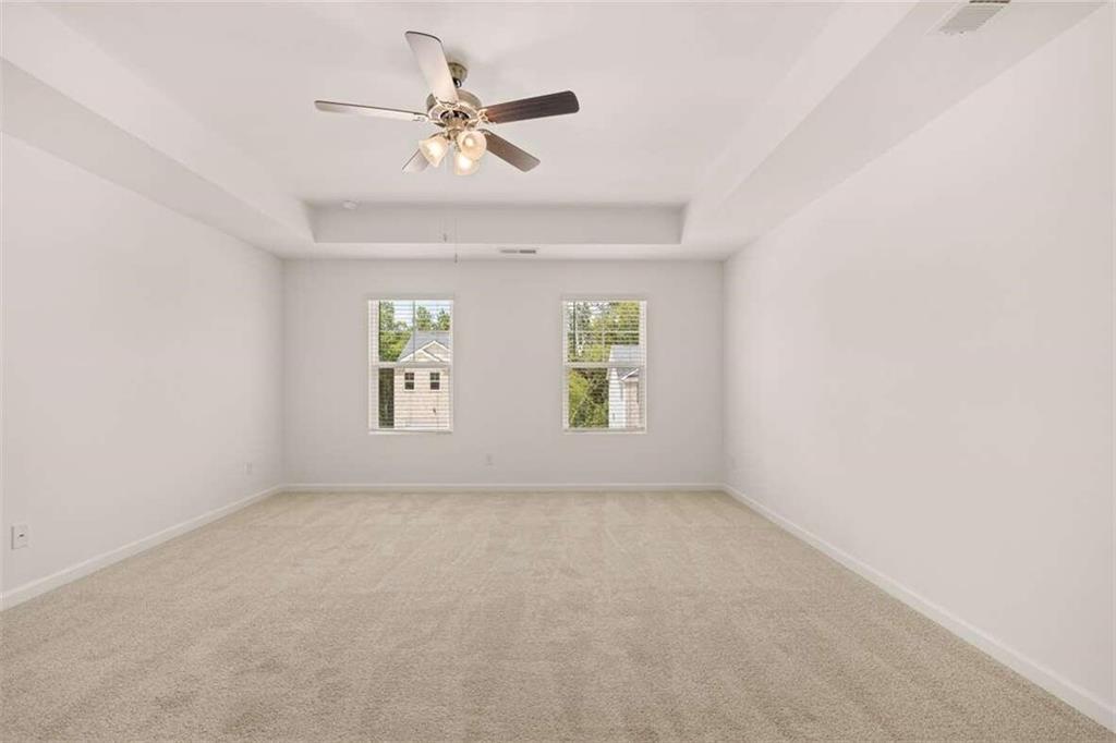 186 Aster Avenue Locust Grove, GA 30248 - Photo 12 of 46 an empty room with windows and fan