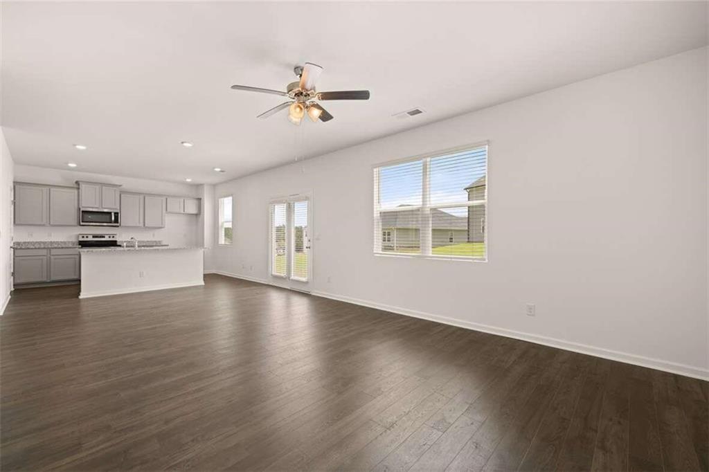 186 Aster Avenue Locust Grove, GA 30248 - Photo 25 of 46 a view of an empty room with wooden floor and a window
