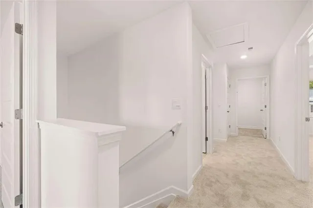 a view of a hallway with an entryway door