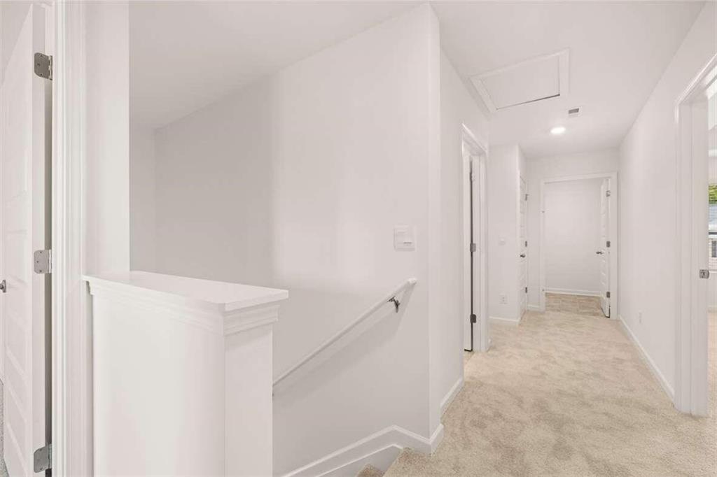 186 Aster Avenue Locust Grove, GA 30248 - Photo 31 of 46 a view of a hallway with white walls
