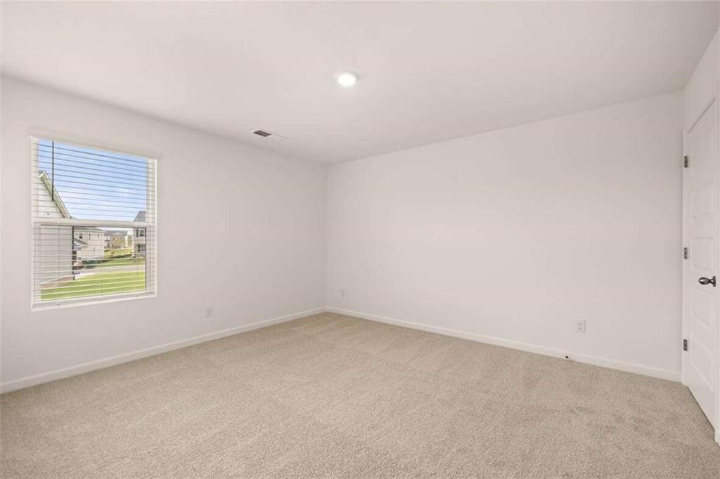 186 Aster Avenue Locust Grove, GA 30248 - Photo 37 of 46 an empty room with a window