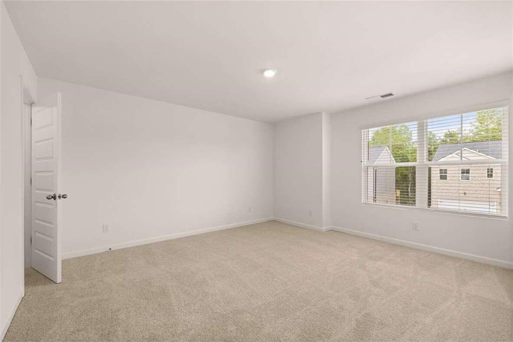 186 Aster Avenue Locust Grove, GA 30248 - Photo 39 of 46 an empty room with windows