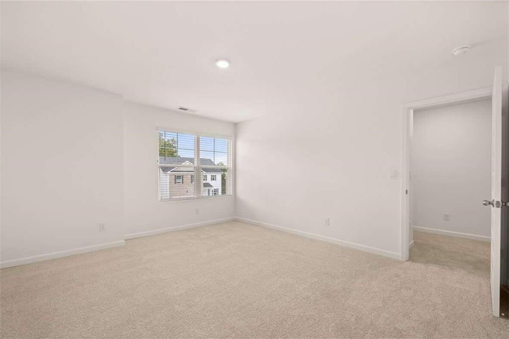 186 Aster Avenue Locust Grove, GA 30248 - Photo 40 of 46 a view of an empty room with a window