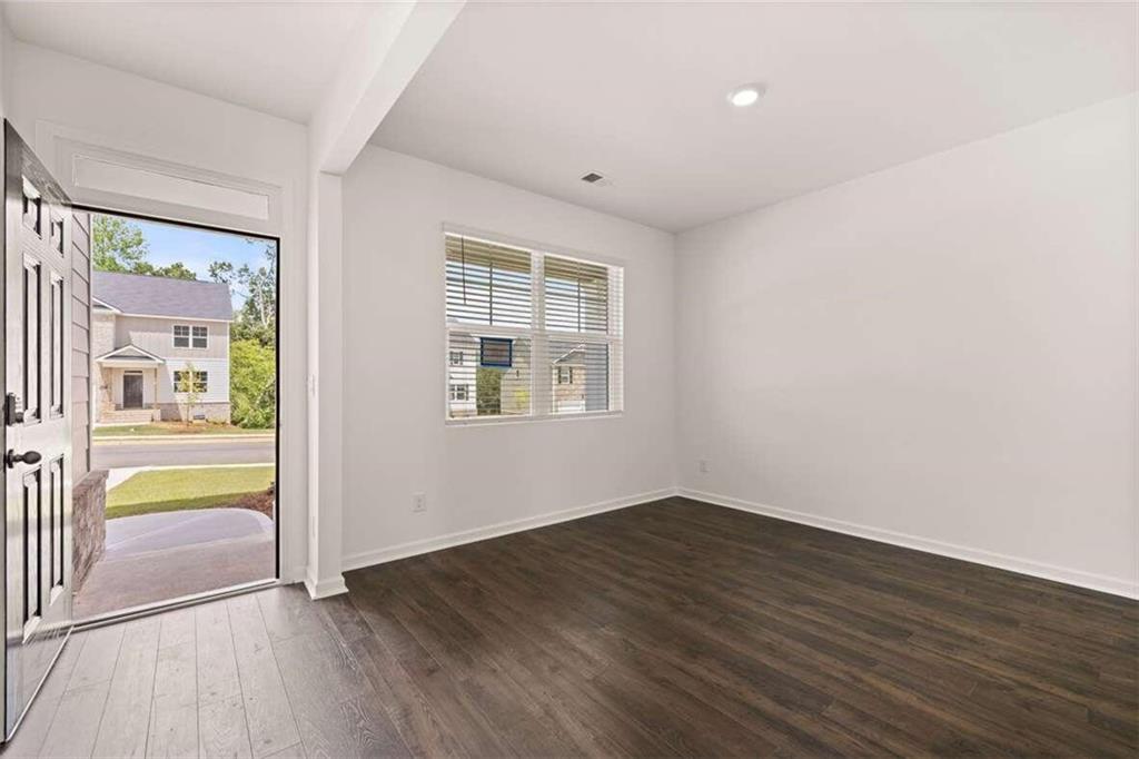 186 Aster Avenue Locust Grove, GA 30248 - Photo 43 of 46 an empty room with wooden floor and a window