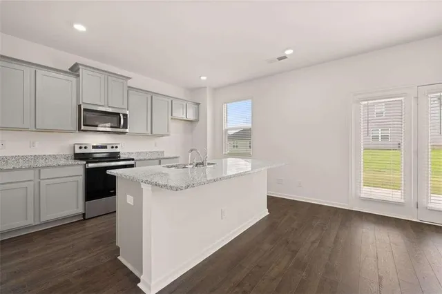 a kitchen that has a sink and a stove