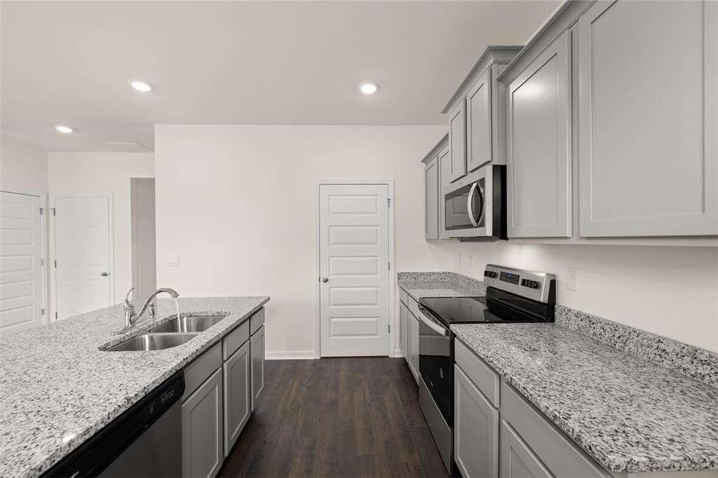 186 Aster Avenue Locust Grove, GA 30248 - Photo 10 of 46 a kitchen that has a sink and a stove