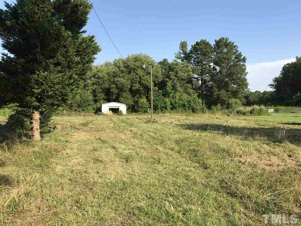 585 Stallings Road Zebulon, NC 27597 - Photo 1 of 3 a view of a field with trees in the background
