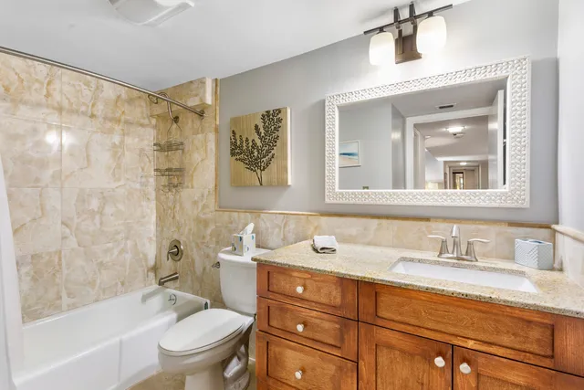 a bathroom with a sink toilet a mirror and shower