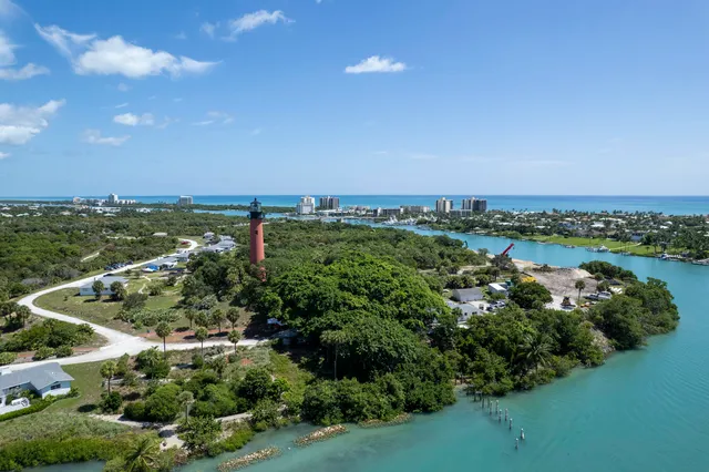 an aerial view of a city with lots of residential buildings and mountain view in back