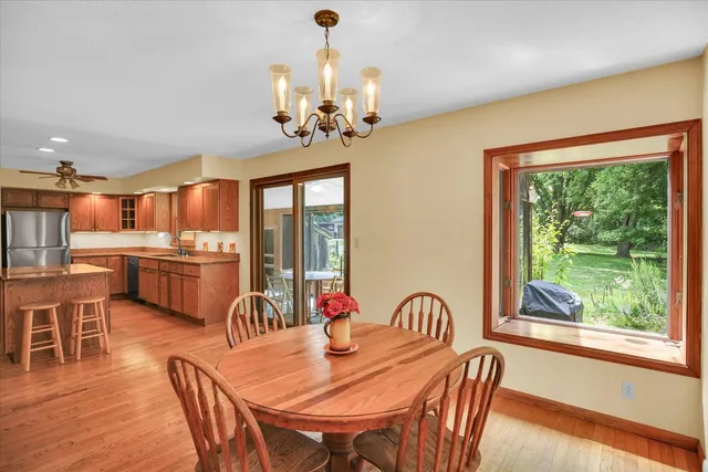 a dining room with furniture window and wooden floor