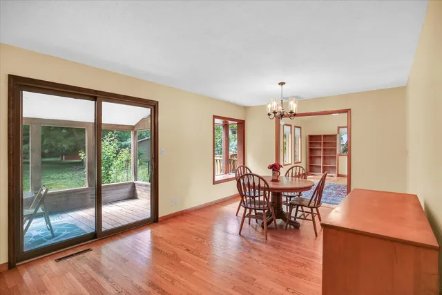 a view of a room with wooden floor and windows