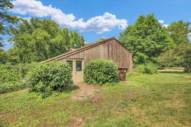 a house with green field in front of it