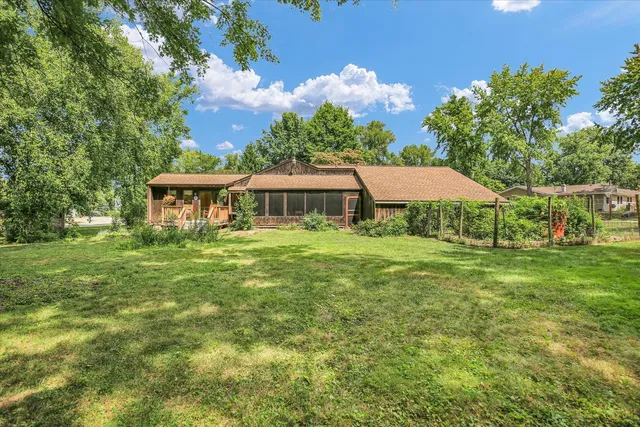 a view of a house with a yard and sitting area