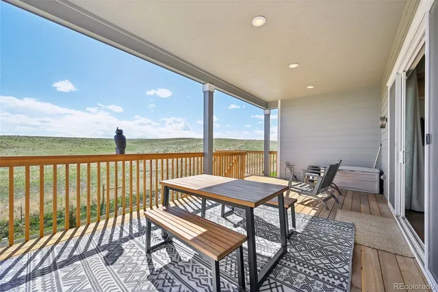 a spacious bedroom with a bed couch and a dresser