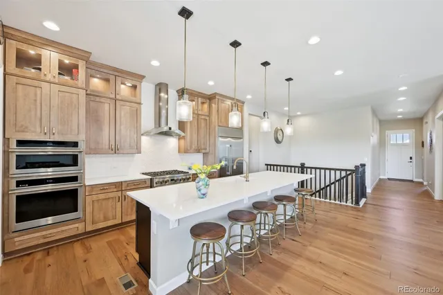 a spacious bathroom with a tub double sink and a mirror