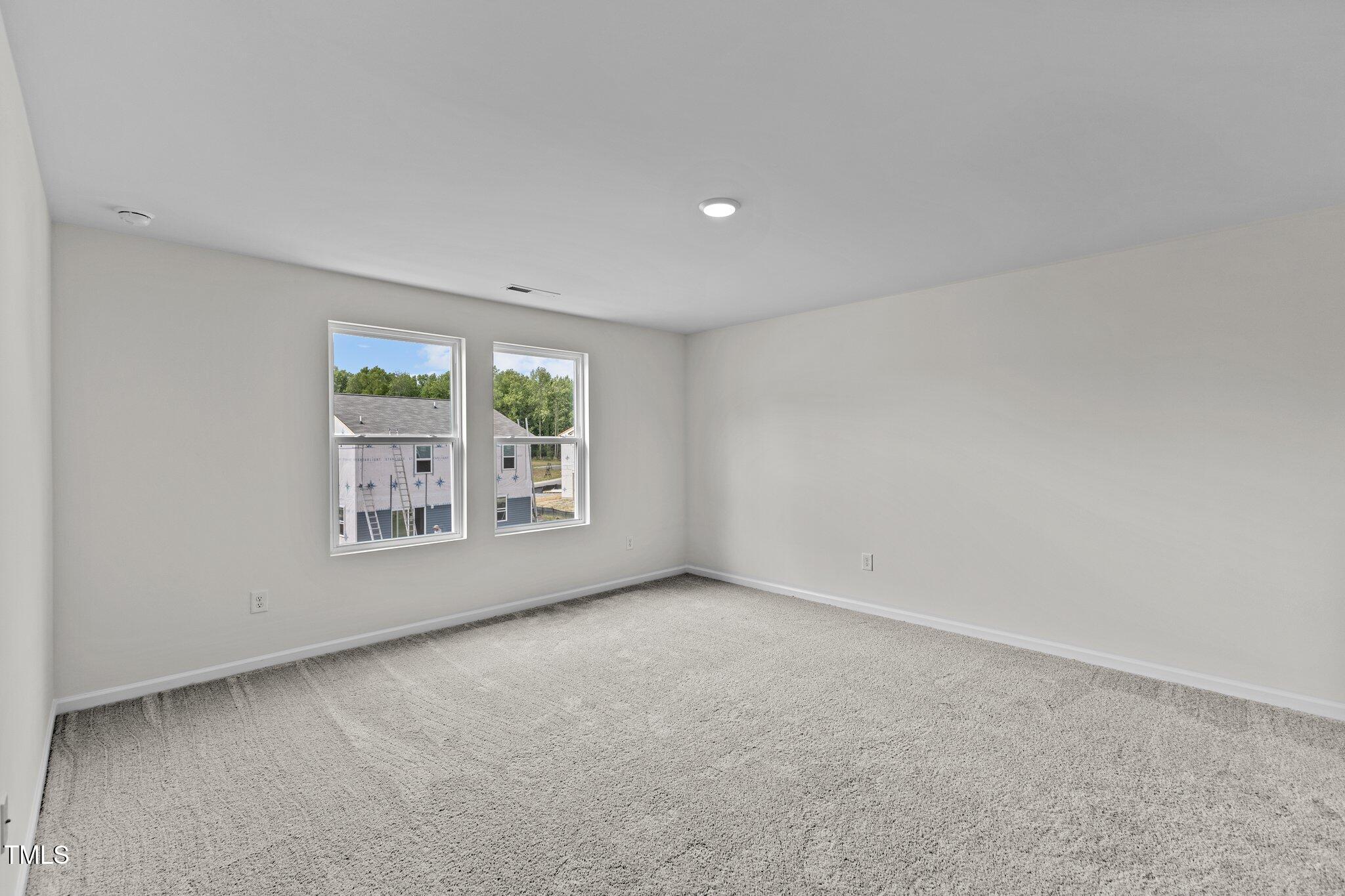 915 Dassault Ln Spring Spring Hope, NC 27882 - Photo 12 of 26 an empty room with windows