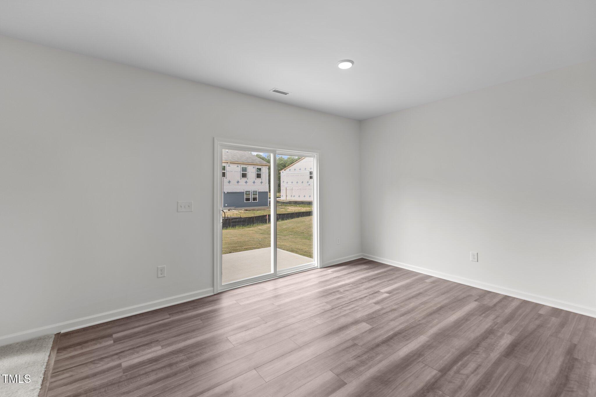 915 Dassault Ln Spring Spring Hope, NC 27882 - Photo 20 of 26 an empty room with wooden floor and closet