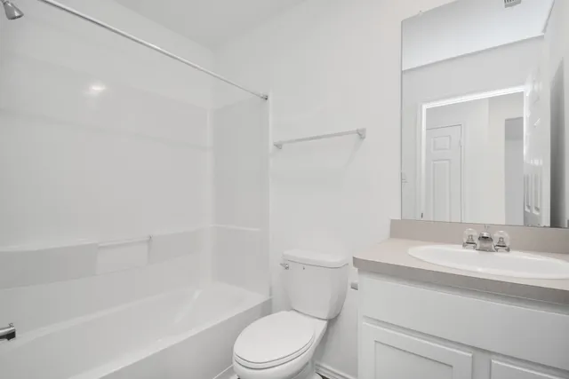 a bathroom with a sink a toilet and a bathtub