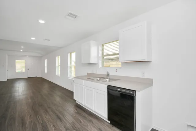 a view of a kitchen cabinets a sink and wooden floor